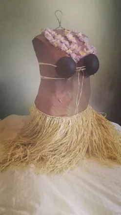 A hula piñata — a torso with a coconut bra and a grass skirt