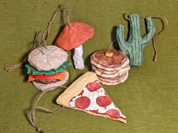 Ornaments — a burger, a mushroom, a cactus, a stack of pancakes and a slice of pizza