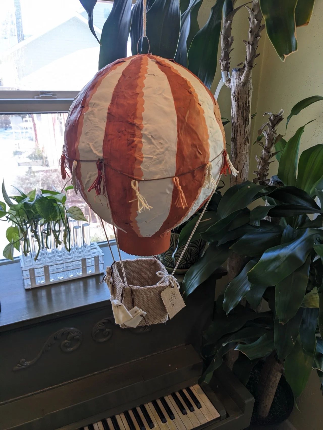 A painted paper mâché hot air balloon hanging in the studio